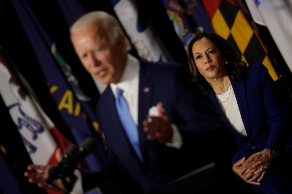 Democratic vice presidential candidate Senator Kamala Harris looks on as presidential candidate and former Vice President Joe Biden speaks at a campaign event, their first joint appearance since Biden ...