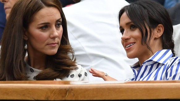 LONDON, ENG - JULY 14: Catherine, Duchess of Cambridge, and Meghan, Duchess of Sussex enjoying the women s singles final at the Wimbledon Championships on July 14, 2018 played at the AELTC, London, En ...