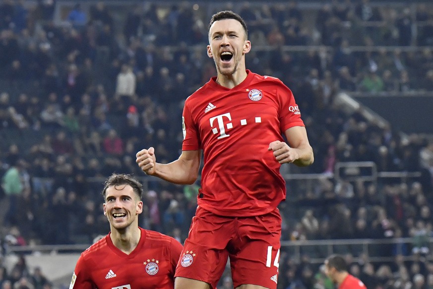 Bayern's Ivan Perisic, top, celebrates after scoring his side's first goal during the German Bundesliga soccer match between Borussia Moenchengladbach and Bayern Munich at the Borussia Park in Moenche ...