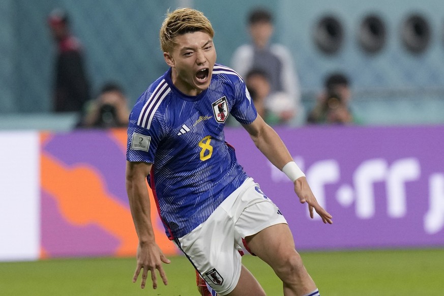 Japan&#039;s Ritsu Doan celebrates scoring his side&#039;s first goal against Spain during a World Cup group E soccer match at the Khalifa International Stadium in Doha, Qatar, Thursday, Dec. 1, 2022. ...