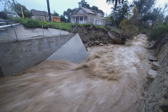 Water rages along Montecito Creek in in Montecito, Calif., Tuesday, Jan. 10, 2023. California saw little relief from drenching rains Tuesday as the latest in a relentless string of storms swamped road ...