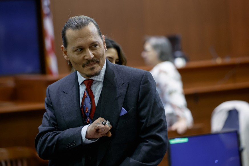 Actor Johnny Depp stands in the courtroom during a break at the Fairfax County Circuit Court in Fairfax, Va., Wednesday, April 27, 2022. Depp sued his ex-wife actress Amber Heard for libel in Fairfax  ...