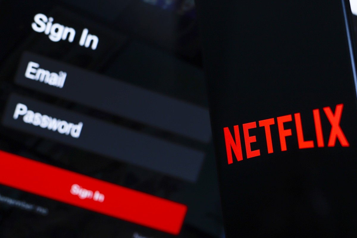 Logo illustration displayed on smartphones in Paraguay - 14 Jul 2024 In this photo illustration, the Netflix logo is displayed on a smartphone screen, next to a login screen, with email, password and  ...