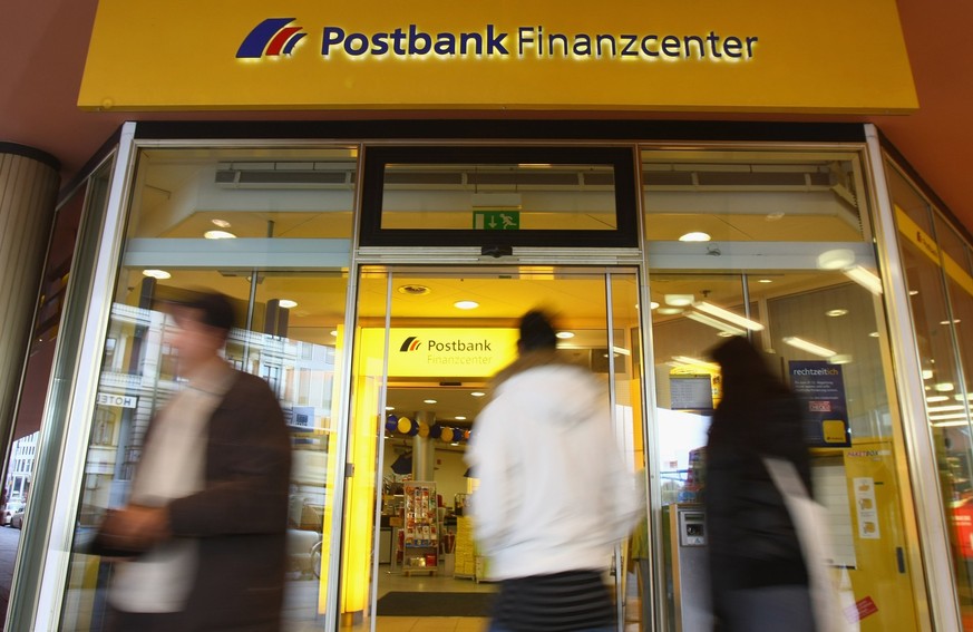 BERLIN - OCTOBER 28: People walk past a branch of German bank Postbank on October 28, 2008 in Berlin, Germany. Postbank announced third quarter losses of EUR 449 million, mainly due to investments rel ...