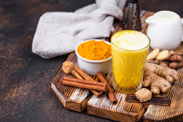 Turmeric golden milk with cinnamon and ginger. Healthy drink