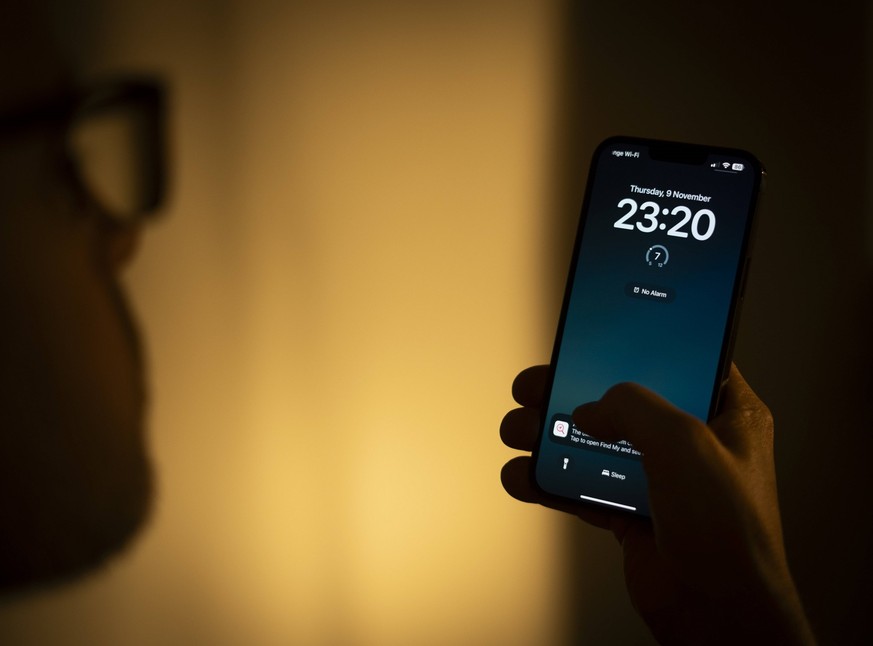 Electronic Portable Device Illustration Images The time is seen displayed on the lock screen of an Apple iPhone in this photo illustration taken on 10 November, 2023 in Warsaw, Poland. Warsaw Poland P ...
