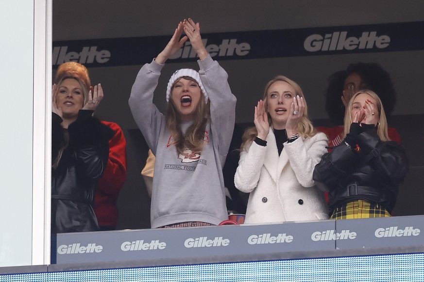 Taylor Swift, center left, reacts with Brittany Mahomes, center right, during the first half of an NFL football game between the Kansas City Chiefs and the New England Patriots, Sunday, Dec. 17, 2023, ...