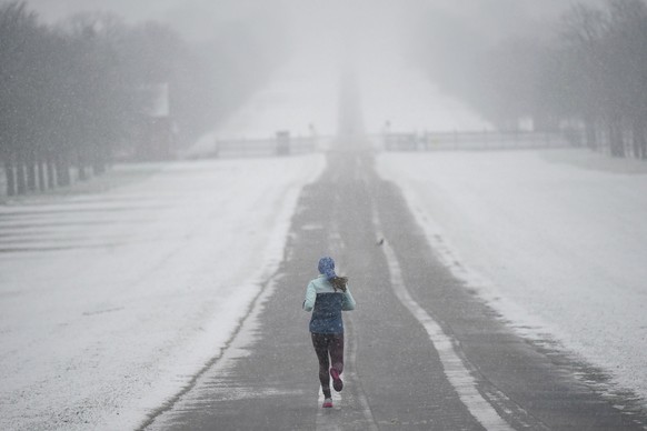 A jogger takes an early morning run in the snow at the Long Walk at Windsor Castle, Berkshire, Wednesday March 8, 2023. Parts of the UK wake up to snow and a yellow weather warning. (Yui Mok/PA via AP ...
