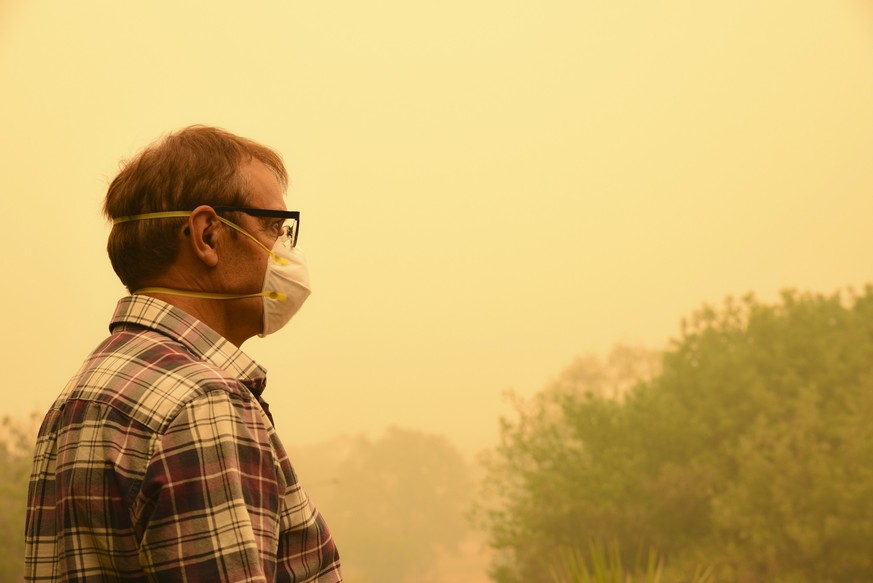 Canberra, Australia, 5/01/2020, Smoke coming from nearby forest fires creates high pollution and covers Canberra with a thick fog. People need to wear mask to breathe.