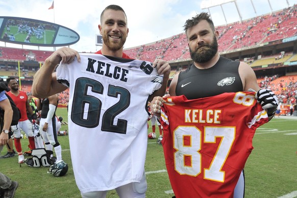 FILE - Kansas City Chiefs tight end Travis Kelce, left, and his brother, Philadelphia Eagles center Jason Kelce (62) exchange jerseys following an NFL football game in Kansas City, Mo., on Sept. 17, 2 ...