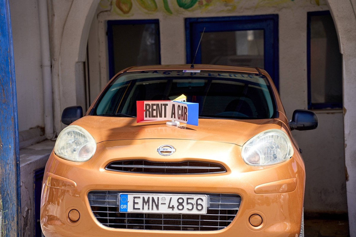 Thira, Santorini, Greece - 8 May 2024: Car rental on Santorini in Greece, A sign with the inscription: Rent a Car, on a vehicle *** Autovermietung auf Santorini in Griechenland, Ein Schild mit Aufschr ...