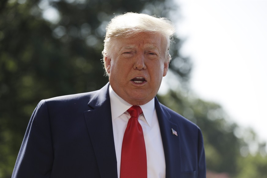 President Donald Trump talks to reporters on the South Lawn of the White House, Friday, Aug. 9, 2019, in Washington. President Trump and first lady Melania Trump are leaving Washington for their annua ...