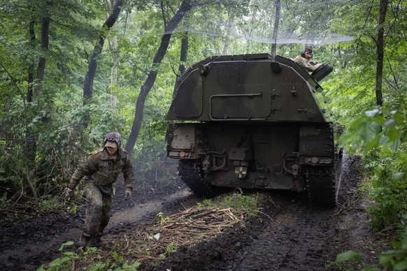 A Ukrainian army, German self-propelled Panzerhaubitze 2000, artillery drives to its position at the frontline near Bakhmut, Donetsk region, Ukraine, Saturday, May 27, 2023. (AP Photo/Efrem Lukatsky)