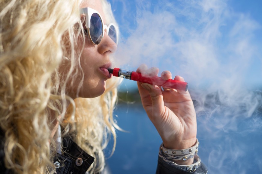 Woman smoking e-cigarette