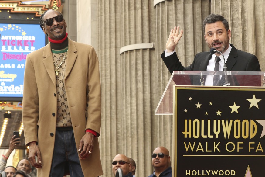 Honoree rapper Snoop Dogg, left, looks on as comedian Jimmy Kimmel speaks during a ceremony honoring him with a star on the Hollywood Walk of Fame on Monday, Nov. 19, 2018, in Los Angeles. (Photo by W ...