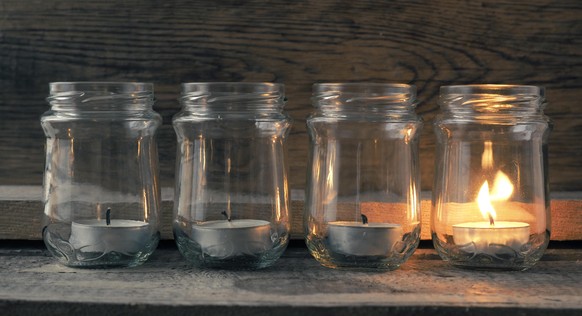 Advent candles burning on a rustic wooden table