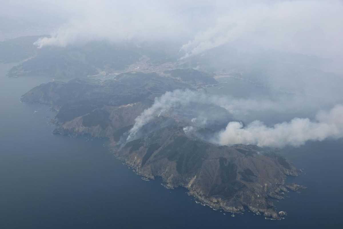 Photo taken from a Kyodo News airplane on Feb. 28, 2025, shows smoke rising as a forest fire continues on a mountain in Ofunato in Iwate Prefecture, northeastern Japan. (Photo by Kyodo News via Getty ...