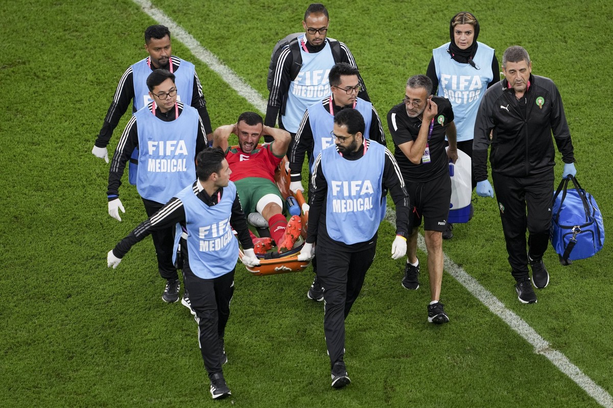 221210 -- DOHA, Dec. 10, 2022 -- Romain Saiss of Morocco is carried out of the pitch on a stretcher during their Quarterfinal of the 2022 FIFA World Cup, WM, Weltmeisterschaft, Fussball at Al Thumama  ...