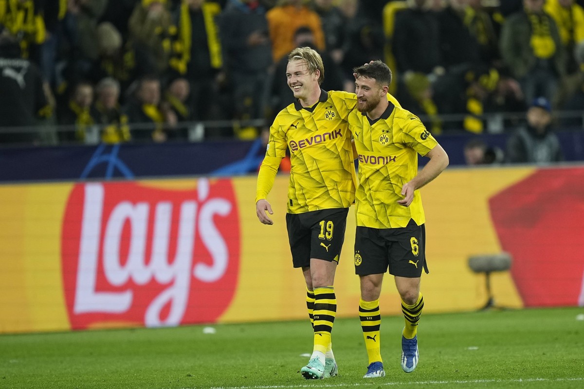 Dortmund's Julian Brandt, left, celebrates with his teammate Salih Ozcan after scoring against Newcastle during the Champions League Group F soccer match between Borussia Dortmund and Newcastle U ...