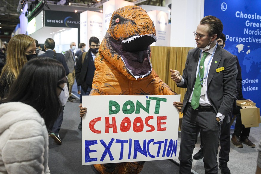 Cop26 - Glasgow An activist dressed as a dinosaur walks though the pavilion section of COP26 on day twelve of the COP 26 United Nations Climate Change Conference on November 11, 2021 in Glasgow, Scotl ...
