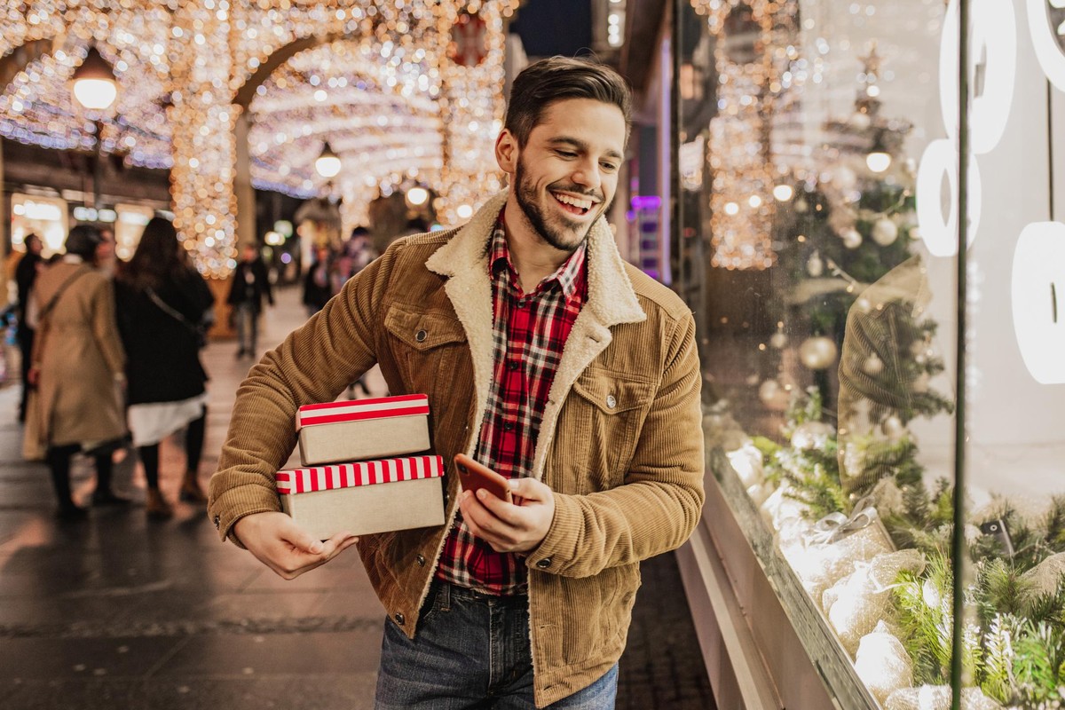 Portrait of a young men holding bags from Christmas shopping