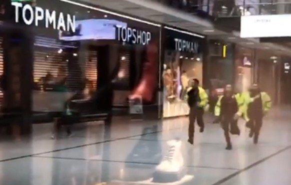 Stabbing at Manchester Arndale Centre. Handout videograb taken with permission from the twitter feed of @GrizzleMarine showing police running through the Arndale Centre in Manchester where at least fo ...