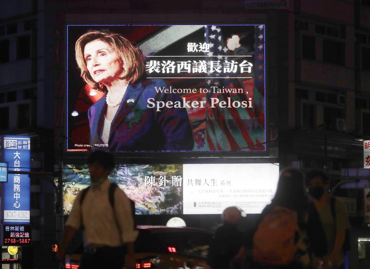 People walk past a billboard welcoming U.S. House Speaker Nancy Pelosi, in Taipei, Taiwan, Tuesday, Aug 2, 2022. U.S. House Speaker Nancy Pelosi was believed headed for Taiwan on Tuesday on a visit th ...