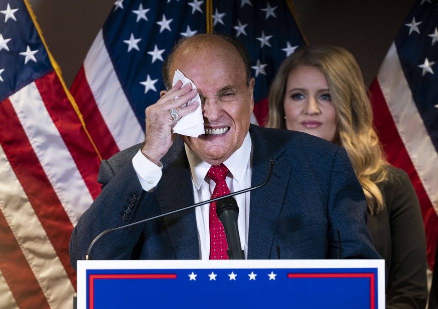 Rudy Giuliani, President Donald Trump s campaign legal advisor, wipes sweat from his face as he speaks on the election results, at the Republican National Committee headquarters in Washington, DC on T ...