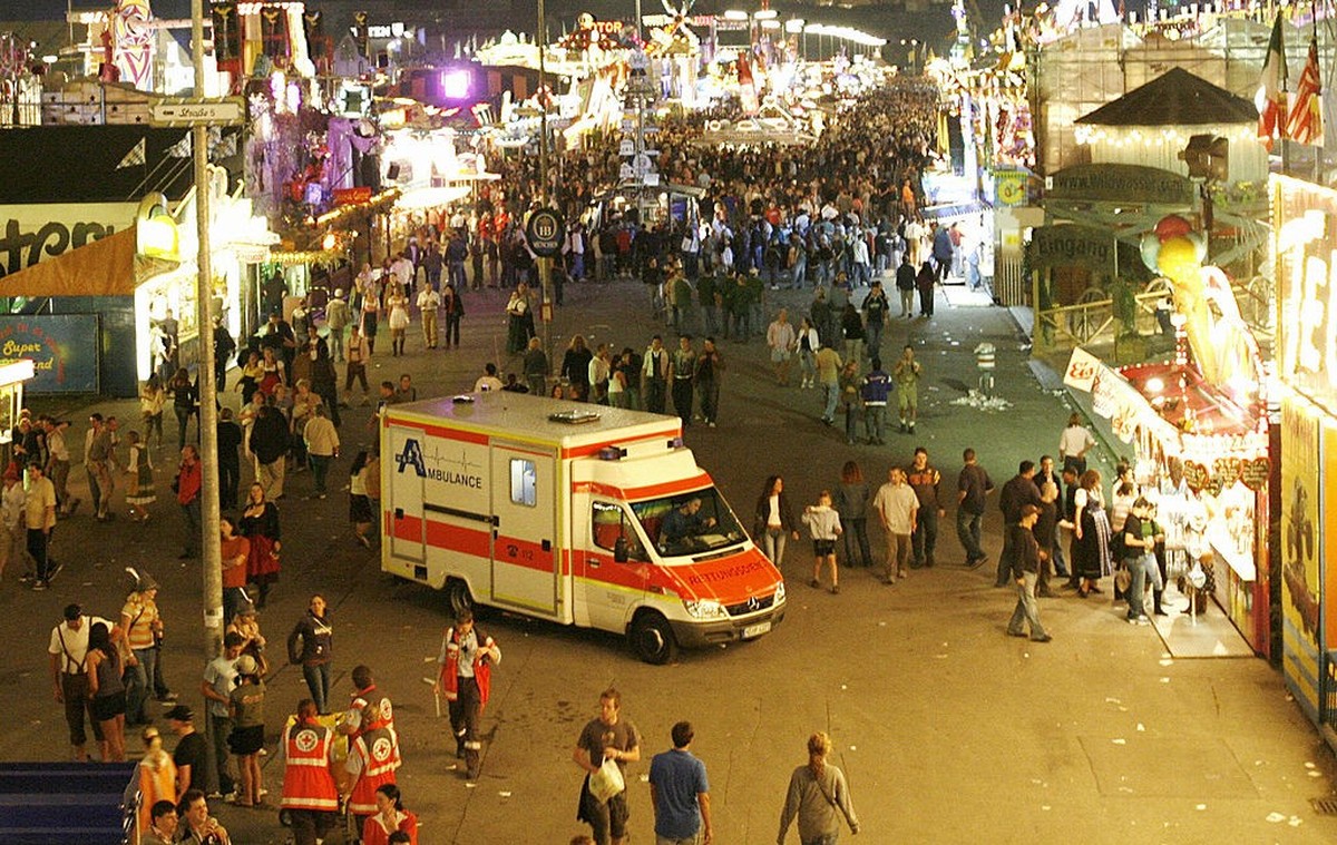 Munich, GERMANY: An ambulance drives through the illuminated Theresienwiese meadow during the opening&#039;s evening of the traditional Oktoberfest beer festival 16 September 2006 in Munich, southern  ...