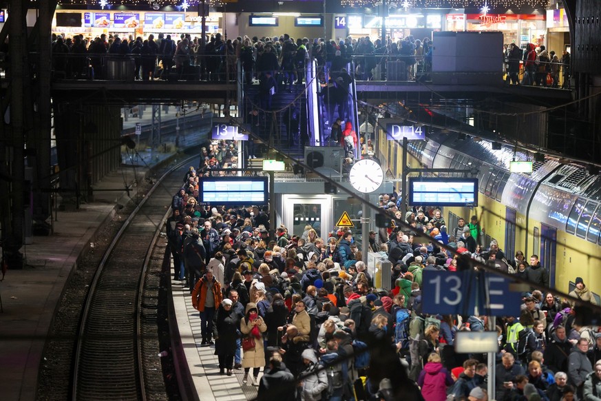 21.12.2023, Hamburg: Zahlreiche Reisende warten auf einem vollem Bahnsteig am Hauptbahnhof auf ihren Zug. Sturmtief