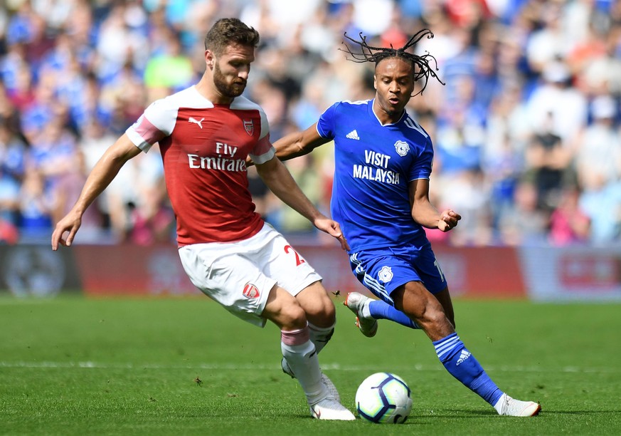 Cardiff City v Arsenal - Premier League - Cardiff City Stadium Arsenal s Shkodran Mustafi (left) and Cardiff City s Bobby Reid battle for the ball EDITORIAL USE ONLY No use with unauthorised audio, vi ...