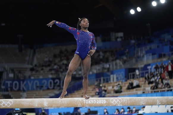 Simone Biles, of the United States, performs on the balance beam during the women's artistic gymnastic qualifications at the 2020 Summer Olympics, Sunday, July 25, 2021, in Tokyo. (AP Photo/Ashle ...
