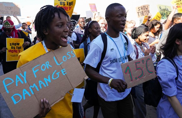 FILE - Vanessa Nakate, of Uganda, left, participates in a Fridays for Future protest at the COP27 U.N. Climate Summit while holding a sign that says &quot;pay for loss and damage&quot;, Friday, Nov. 1 ...