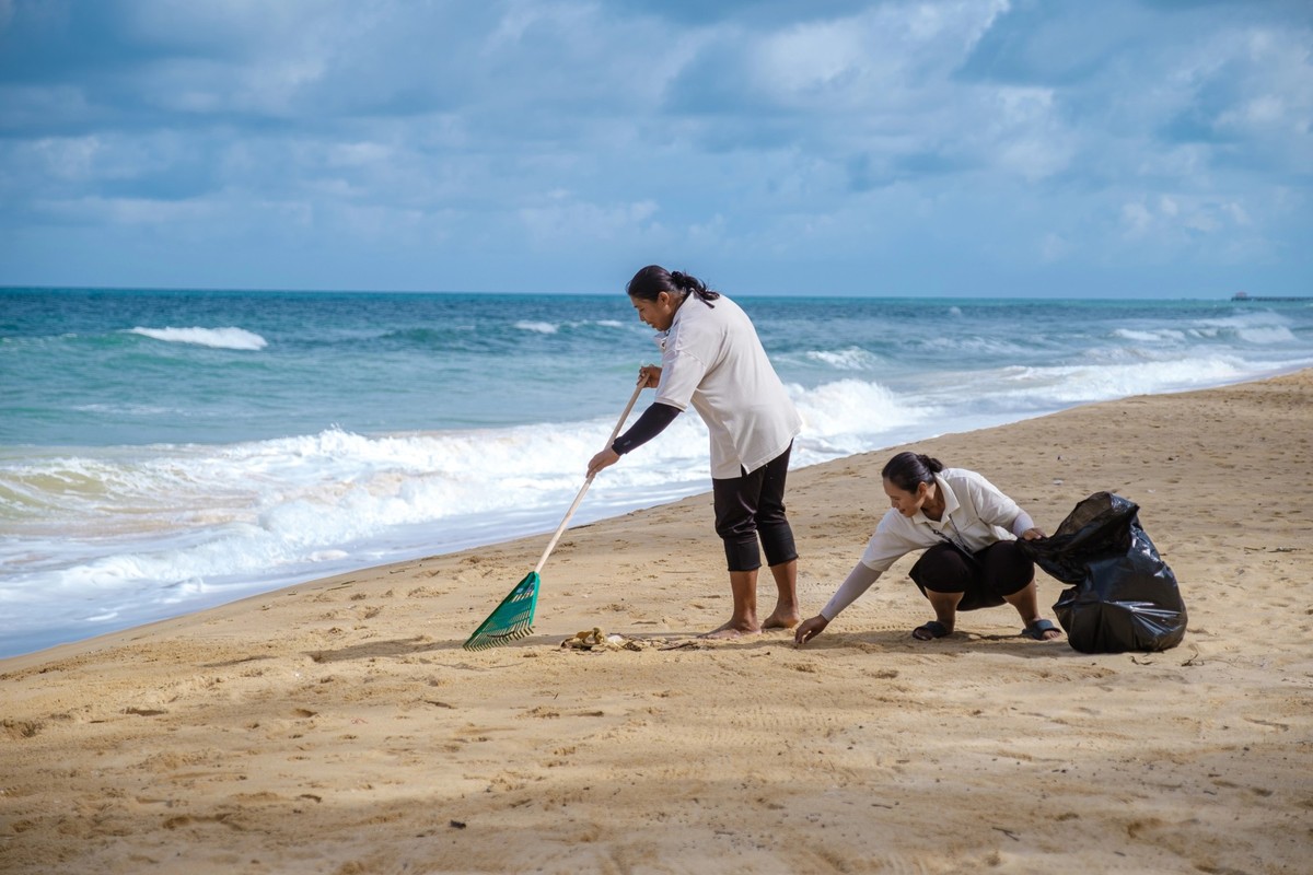People are cleaning plastic garbage waste on the beach of Phuket Thailand July 2022