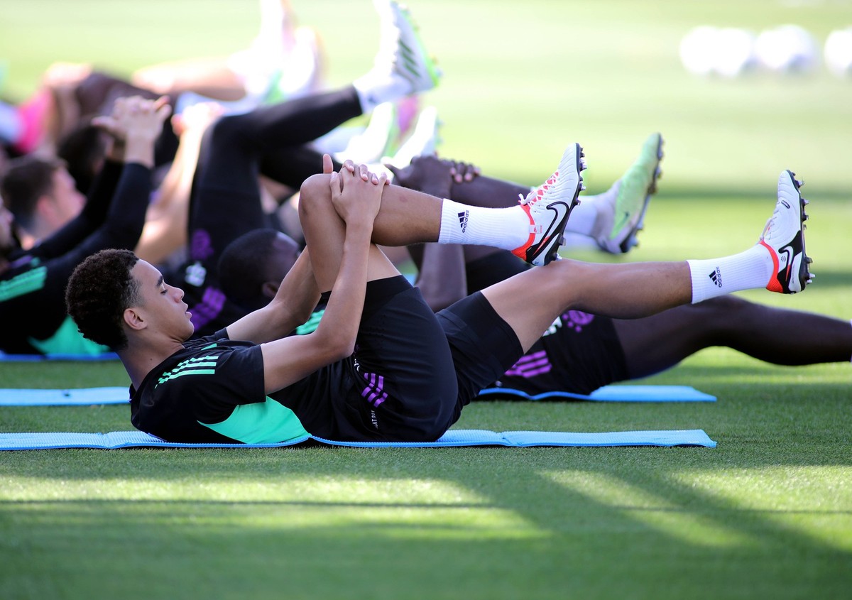 M�nchen, Deutschland 22. August 2023: Fussball, Herren, Saison 2023/2024, FC Bayern M�nchen,Training, S�benerstrasse Jamal Musiala FC Bayern M�nchen h�lt sich das Knie beim Dehnen, liegend am Boden, b ...