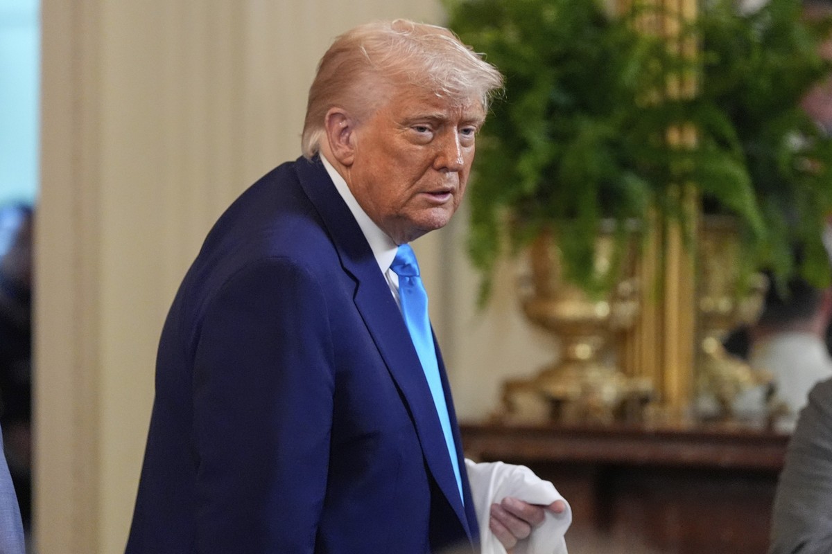 President Donald Trump holds a jersey as he departs after hosting the 2025 NCAA Champion, University of Florida men&#039;s basketball team in the East Room of the White House, Wednesday, May 21, 2025, ...