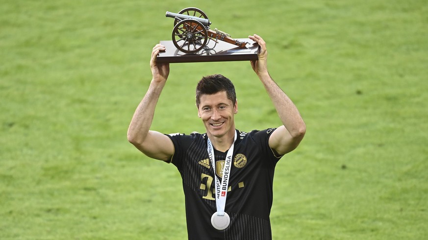 Bayern's Robert Lewandowski holds a trophy of the best scorer of the season after winning the Bundesliga title after the German Bundesliga soccer match between Bayern Munich and FC Augsburg at the All ...