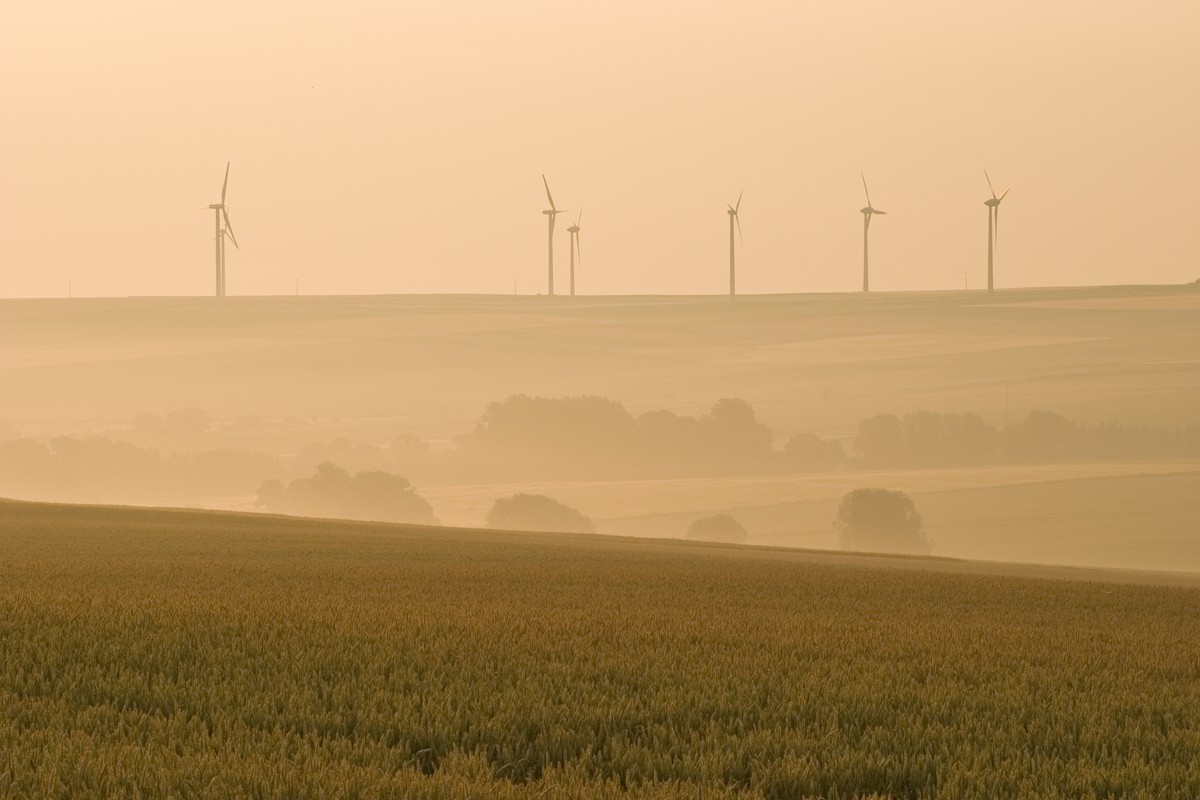 "Morning shot in the rural Palatinate, Germany, taken during the heatwave in summer 2006. The download in AdobeRGB looks more impressive. No motion blur in the wind turbines."