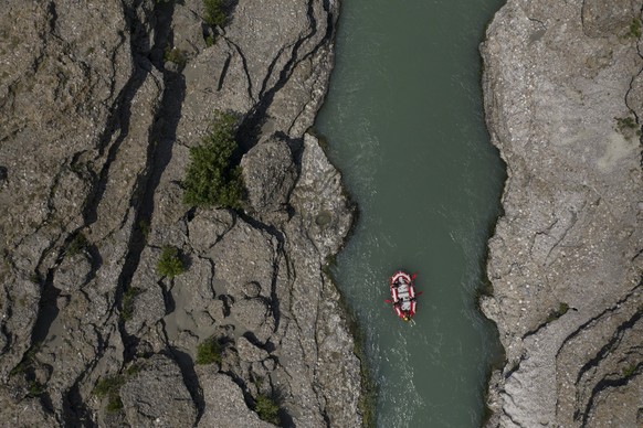 FILE - People raft on the Vjosa River near Permet, Albania, June 25, 2019. The Albanian government on Wednesday, March 15, 2023 formally designated the Vjosa River and its tributaries a national park, ...