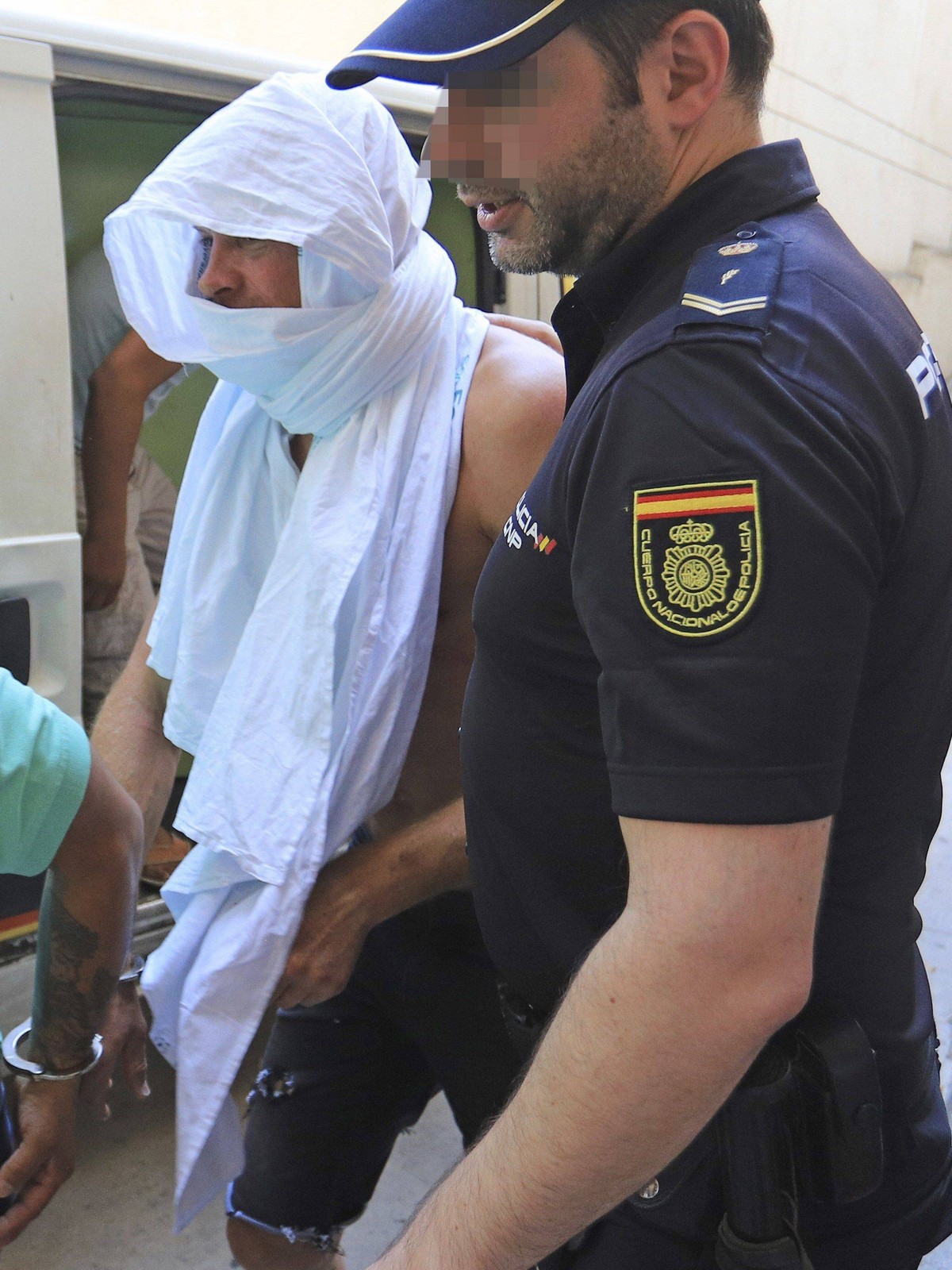 German former rider Jan Ullrich (C) is escorted by Spain s National Police member upon arrival at Palma de Mallorca s court in Mallorca, Balearic Islands. Ullrich was arrested for allegedly forcibly e ...