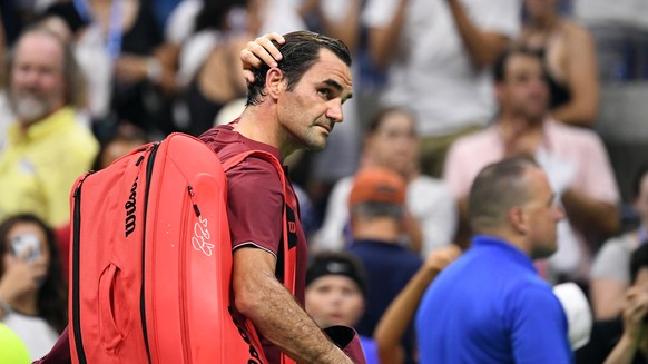 Sep 3, 2018; New York, NY, USA; Roger Federer of Switzerland walks off the court after his loss to John Millman of Australia celebrates in a round of 16 match on day eight of the 2018 U.S. Open tennis ...