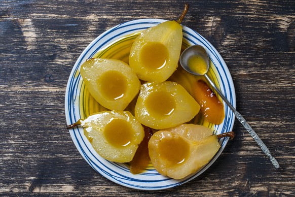 Baked pears in orange juice, close up, top view. Delicious dessert.