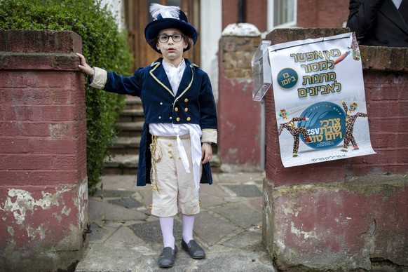 March 21, 2019 - London, UK, United Kingdom - Orthodox couple seen wearing fancy dresses during the festival of Purim on the streets of Stamford Hill in north London..Purim is one of the most entertai ...