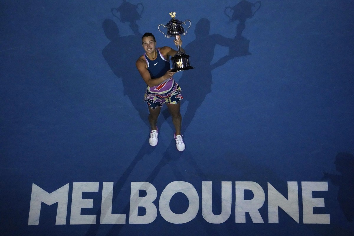 Aryna Sabalenka of Belarus holds the Daphne Akhurst Memorial Trophy aloft after defeating Elena Rybakina of Kazakhstan in the women&#039;s singles final at the Australian Open tennis championship in M ...