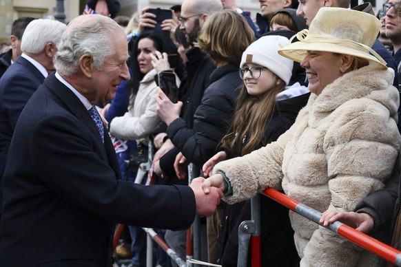 Britain&#039;s King Charles III greets a member of the public as he visits Berlin, Germany, March 29, 2023. (Wolfgang Rattay/Pool via AP)