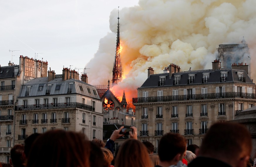 Smoke billows as fire engulfs the spire of Notre Dame Cathedral in Paris, France April 15, 2019. REUTERS/Benoit Tessier/File Photo SEARCH &quot;GLOBAL POY&quot; FOR THIS STORY. SEARCH &quot;REUTERS PO ...