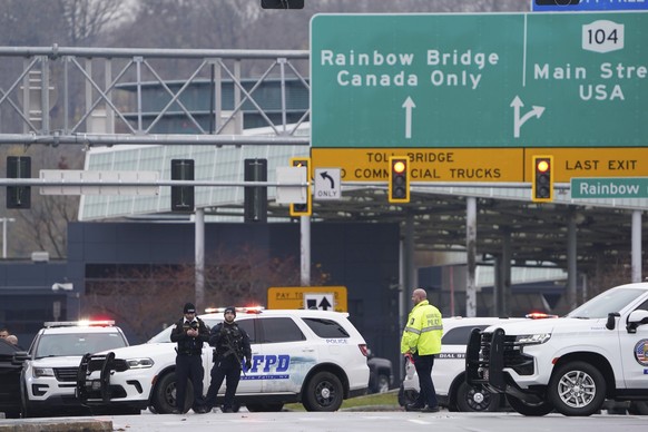 Law enforcement personnel block off the entrance to the Rainbow Bridge, Wednesday, Nov. 22, 2023, in Niagara Falls, N.Y. The border crossing between the U.S. and Canada has been closed after a vehicle ...