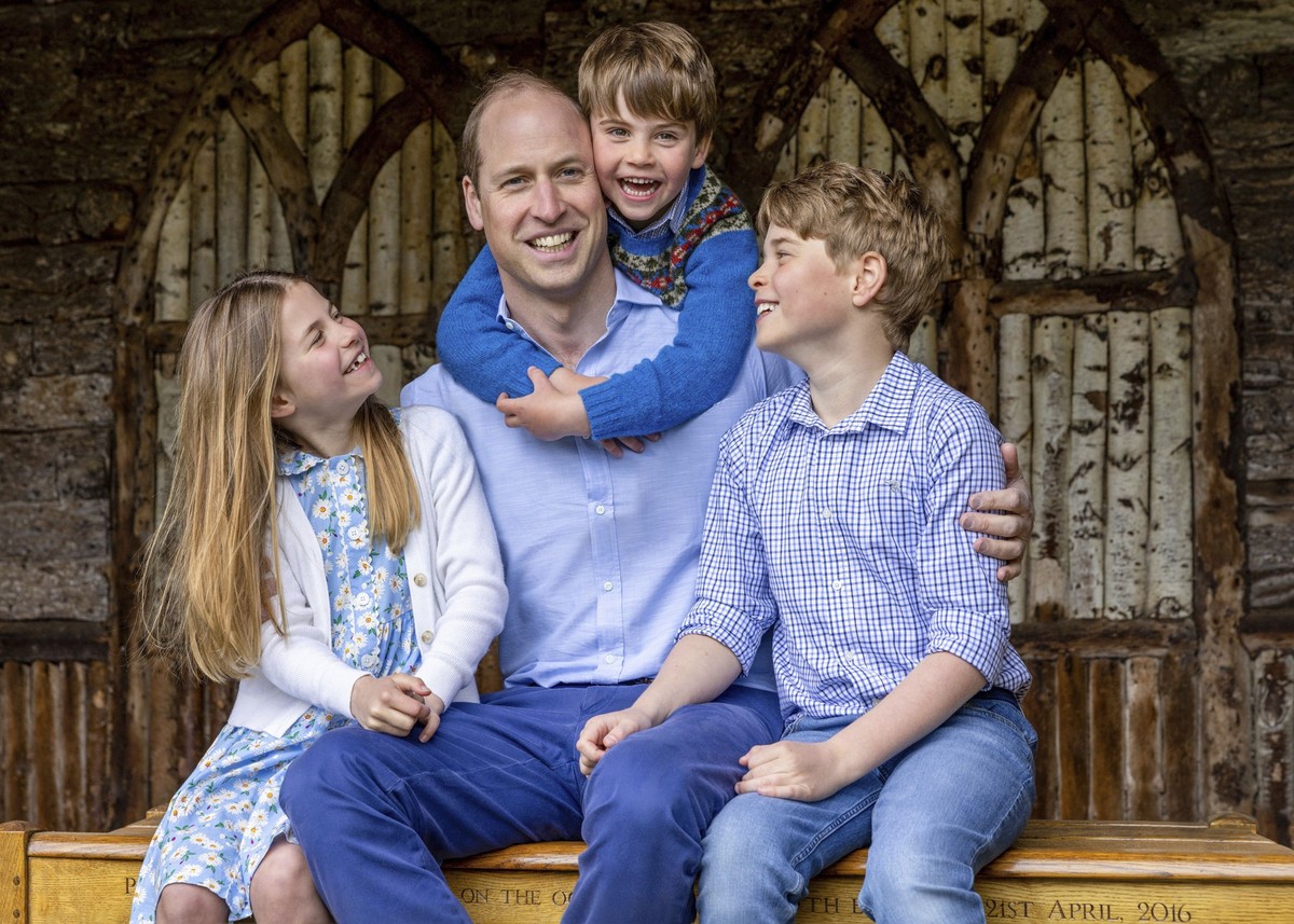 William, the Prince of Wales, sits with his children Princess Charlotte, Prince Louis and Prince George, right, Saturday June 17, 2023, ahead of Father's Day. (Millie Pilkington/Kensington Palace ...