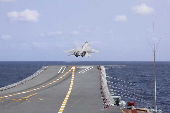 FILE - In this photo released by Xinhua News Agency, a J-15 Chinese fighter jet takes off from the Shandong aircraft carrier during the combat readiness patrol and military exercises around the Taiwan ...