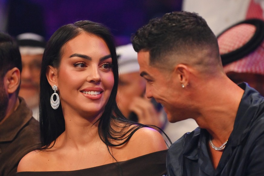 RIYADH, SAUDI ARABIA - OCTOBER 28: Cristiano Ronaldo and his wife Georgina Rodríguez speak ringside prior to the Heavyweight fight between Tyson Fury and Francis Ngannou at Boulevard Hall on October 2 ...